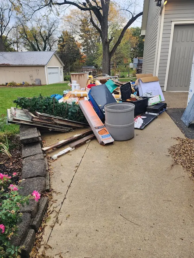 Dumpster being loaded with debris for Commercial Dumpster Rental in New Bedford